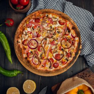 a pizza with tomatoes and onions